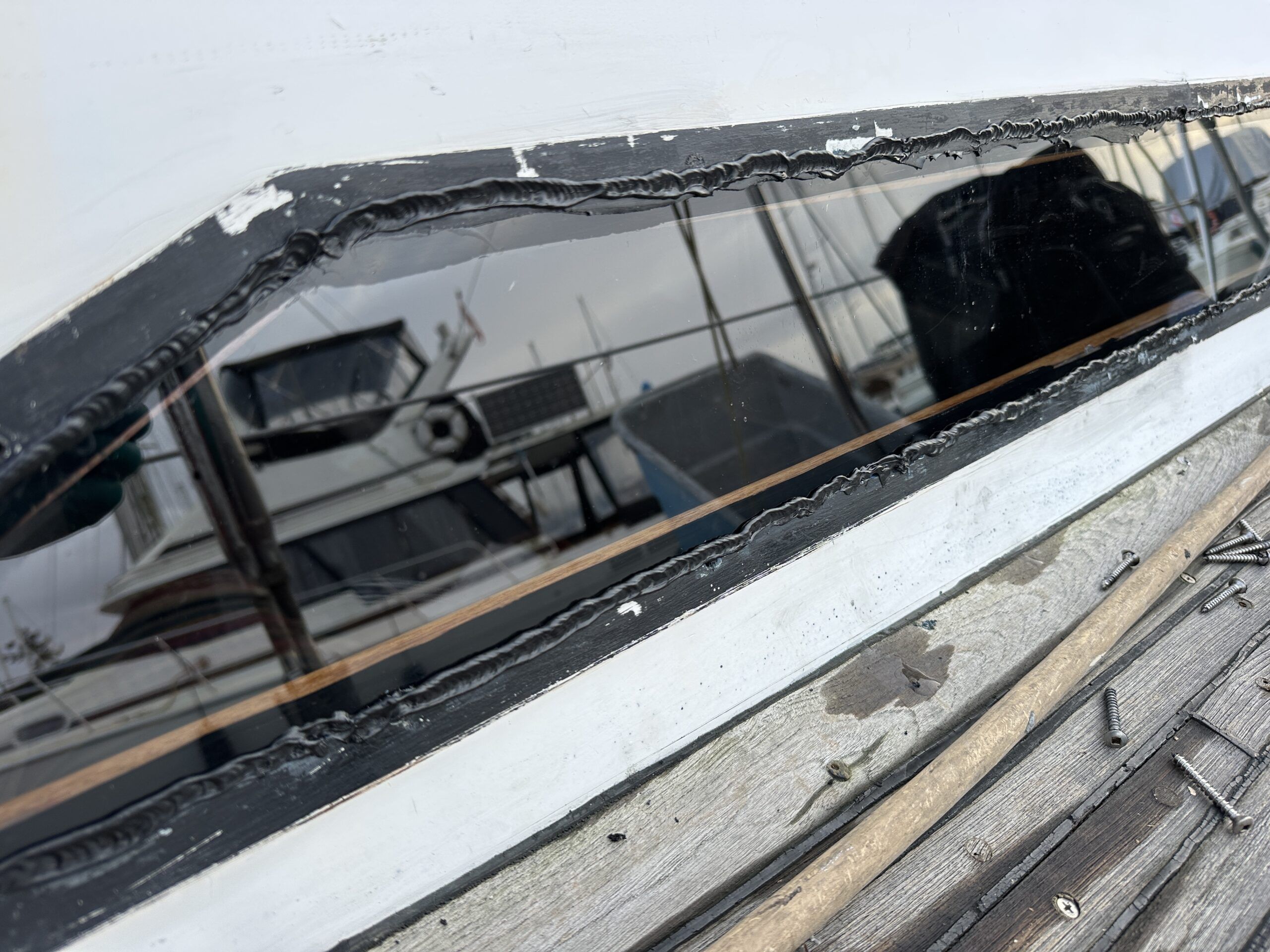 A bead of Sikaflex pressed into the gap between the window and cabin top, with enough applied to create a seal with the stainless steel frame.(Photo/ Bert Vermeer)