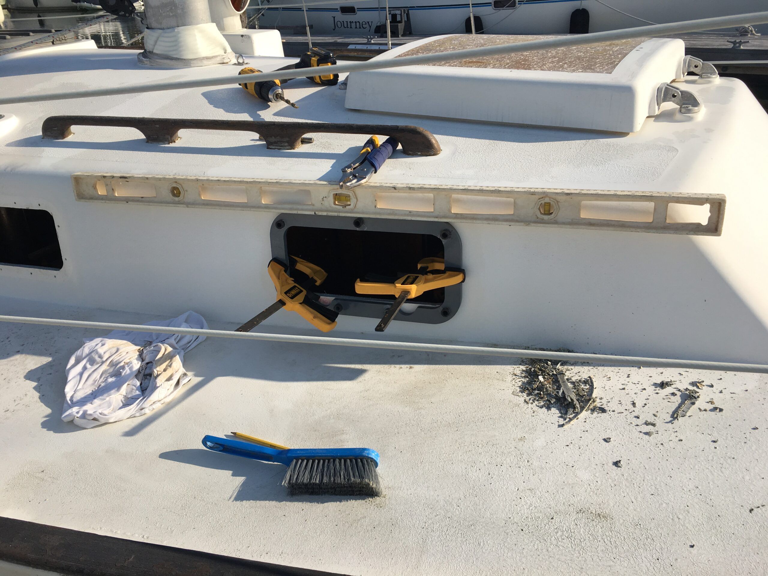 New Found Metals' cutting template in place to modify the portlight opening. (Photo/ Bert Vermeer)