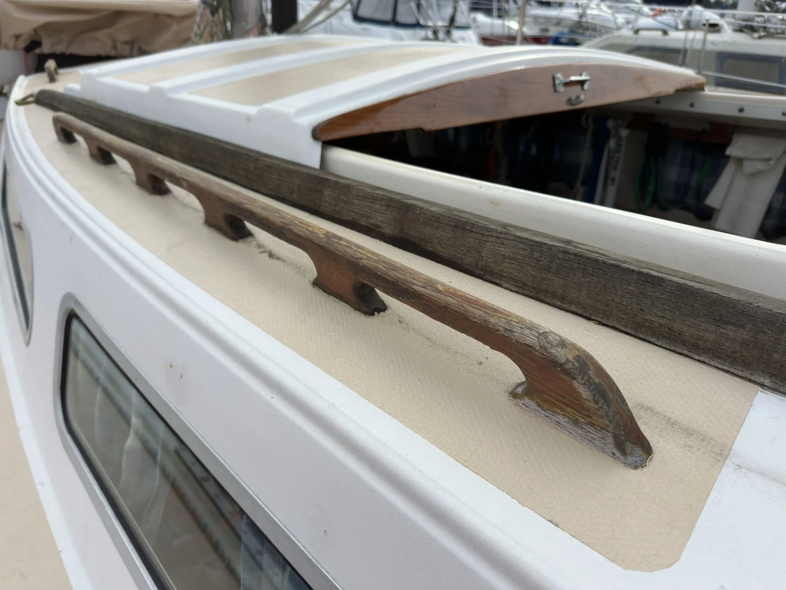 Catalina 27 with badly weathered cockpit slide and failed varnish on the handrails. (Photo/ Bert Vermeer)