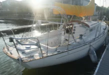 Common age-related issues to watch for during a pre-purchase survey include delamination in the balsa-cored decks and crazing around stanchion bases. The cockpit is deep and secure for offshore work, but the wheel pedestal’s position tight against the bridge deck can make viewing engine instruments difficult and complicates the installation of a modern chartplotter. Photo courtesy of YachtWorld.com