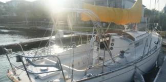 Common age-related issues to watch for during a pre-purchase survey include delamination in the balsa-cored decks and crazing around stanchion bases. The cockpit is deep and secure for offshore work, but the wheel pedestal’s position tight against the bridge deck can make viewing engine instruments difficult and complicates the installation of a modern chartplotter. Photo courtesy of YachtWorld.com