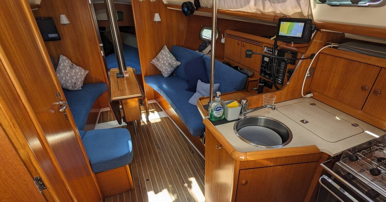 Generous use of teak and teak veneers, along with strategically placed portlights and hatches, creates a sense of spaciousness throughout the 9-ft. 6-in. cabin despite the boat's modest beam. Courtesy of Yachts.co