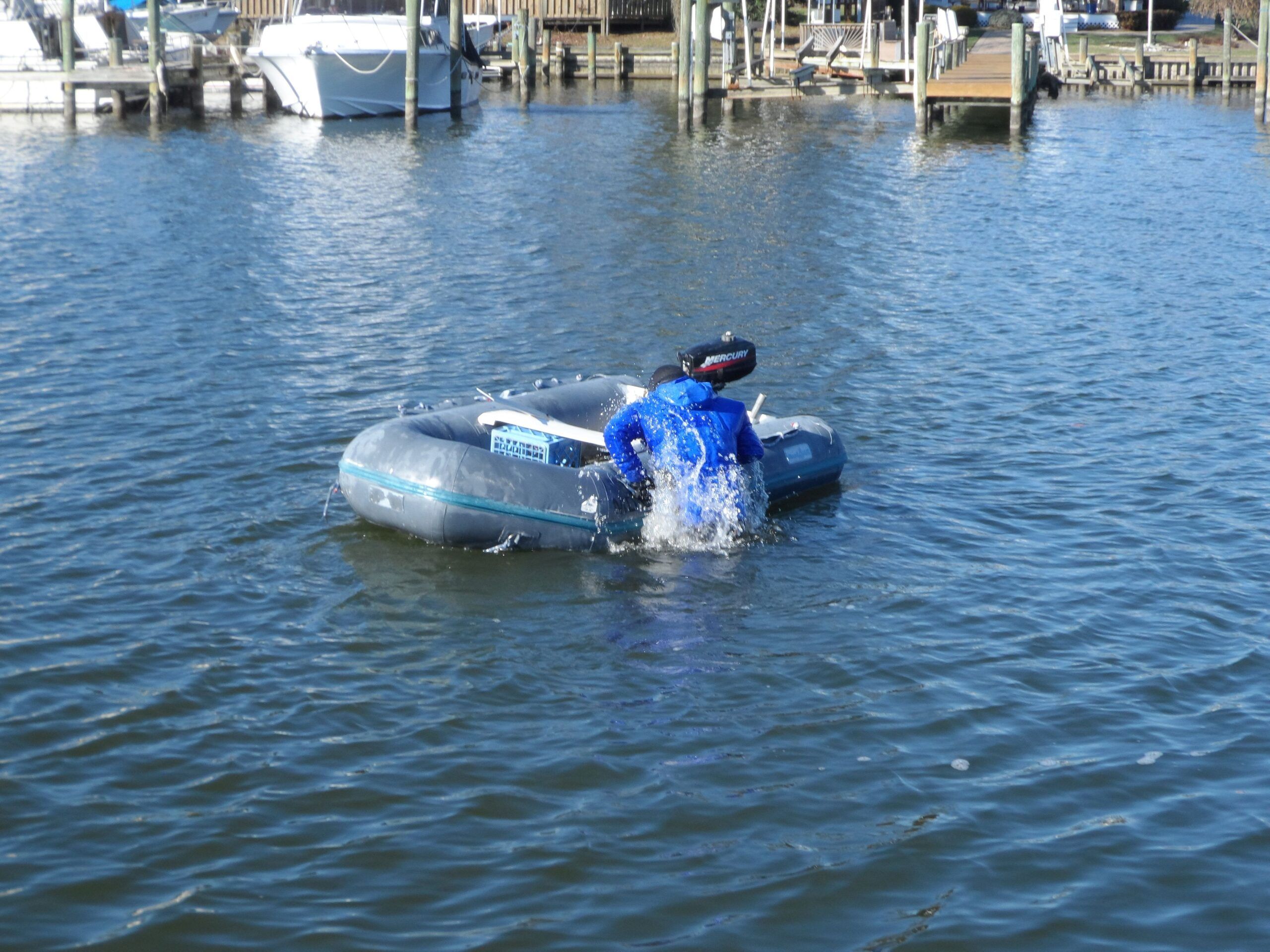 Boarding the dinghy in a dry suit. Boarding an inflatable without assistance is a required CG test. It was easy in the dry suit. (Photo/ Drew Frye)