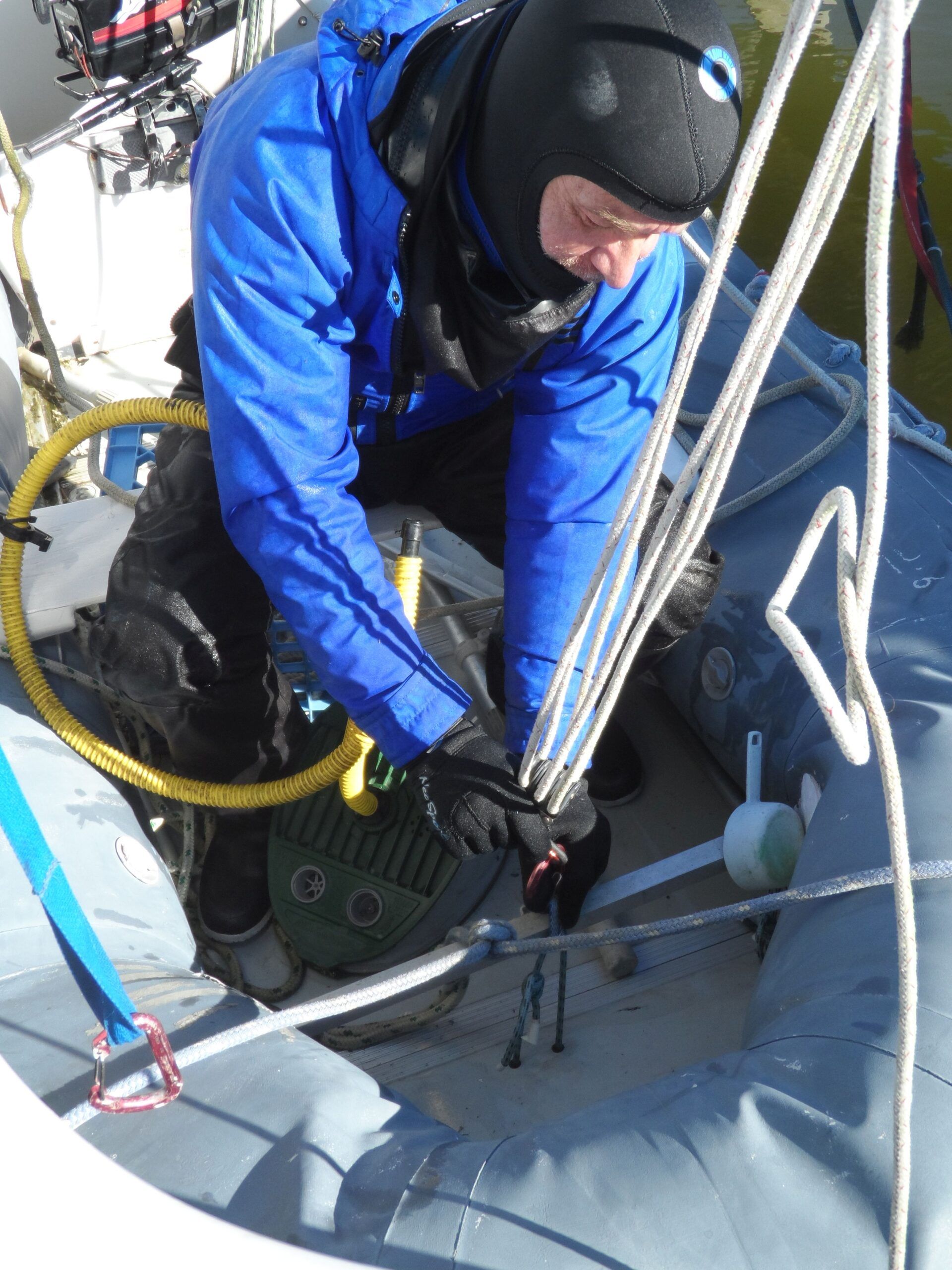 Clipping carabiners and working Fastex buckles is easy with neoprene gloves. In fact, I launched the dinghy from davits and added some air while I was at it. (Photo/ Drew Frye)