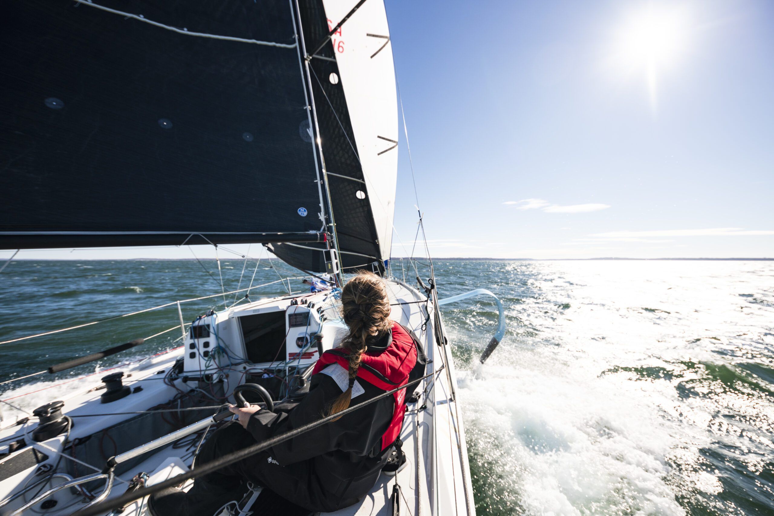 The Figaro 3's twin rudders maintain steering control even when heeled over, and its foils and deep keel provide impressive stability—sailors typically don't reef until wind reaches a consistent 30 knots. (Photo/ <a href="“https://www.catebrownphoto.com/-/galleries/portfolios/sail”">Cate Brown Photography</a>)