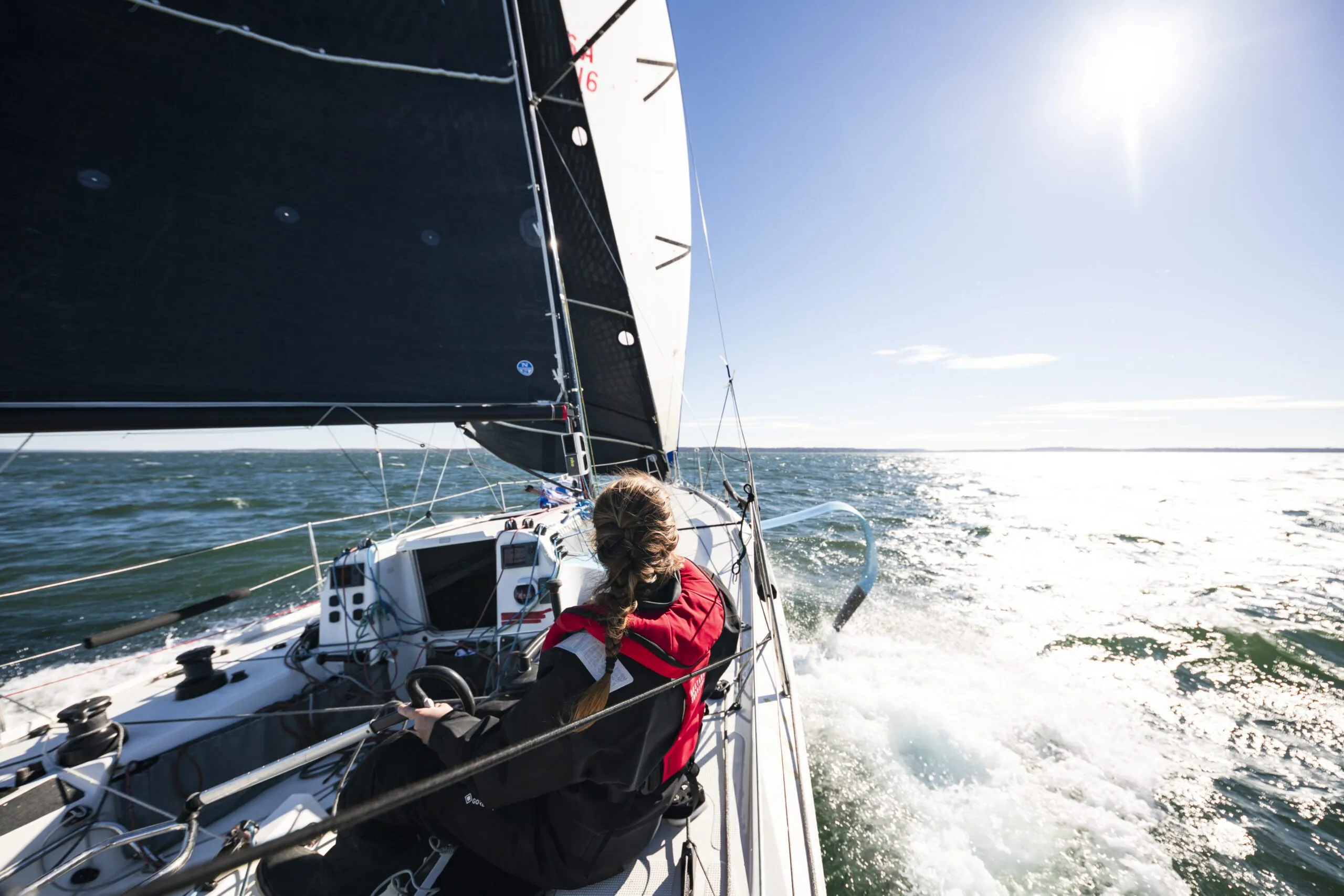 The Figaro 3's twin rudders maintain steering control even when heeled over, and its foils and deep keel provide impressive stability—sailors typically don't reef until wind reaches a consistent 30 knots. (Photo/ <a href="“https://www.catebrownphoto.com/-/galleries/portfolios/sail”">Cate Brown Photography</a>)