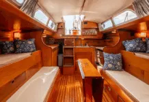 Hinckley Bermuda 40 Used Boat Review Pilot berths flanking extension settees create four sleeping berths, though the layout pushes furniture toward centerline—a tradeoff for the wide sidedecks that enhance safety. Courtesy of YachtWorld.com