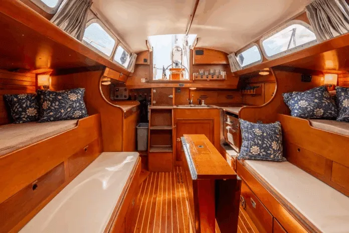 Hinckley 40-interior Pilot berths flanking extension settees create four sleeping berths, though the layout pushes furniture toward centerline—a tradeoff for the wide sidedecks that enhance safety. Courtesy of YachtWorld.com