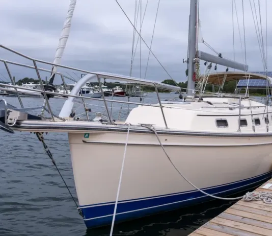 Island Packet Estero Used Boat Review The Estero's high freeboard, buff-colored gelcoat and bowsprit give her the look of a classic cruiser without the burden of teak maintenance. (Photo/ McCann Yachts)