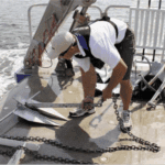 Anchors on the University of Maryland’s Rachel Carson are prepared for deployment into the Chesapeake Bay muck.