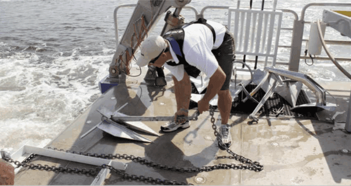 Anchors on the University of Maryland’s Rachel Carson are prepared for deployment into the Chesapeake Bay muck.