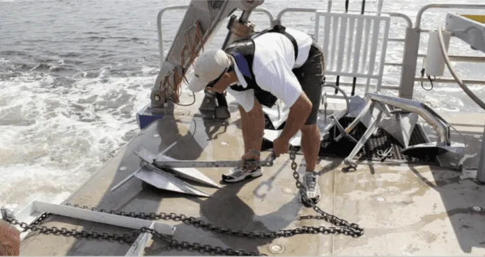 Anchors on the University of Maryland’s Rachel Carson are prepared for deployment into the Chesapeake Bay muck.