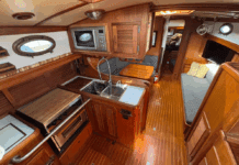 The Union 36's U-shaped galley to port features a deep double sink, three-burner stove/oven, and meticulous teak joinery throughout. (Photo courtesy of YachtWorld.com)