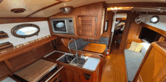 The Union 36's U-shaped galley to port features a deep double sink, three-burner stove/oven, and meticulous teak joinery throughout. (Photo courtesy of YachtWorld.com)