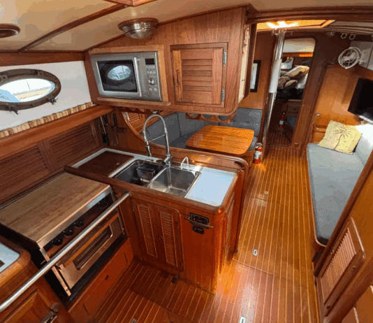 Union 36 Used Boat Review The Union 36's U-shaped galley to port features a deep double sink, three-burner stove/oven, and meticulous teak joinery throughout. (Photo courtesy of YachtWorld.com)