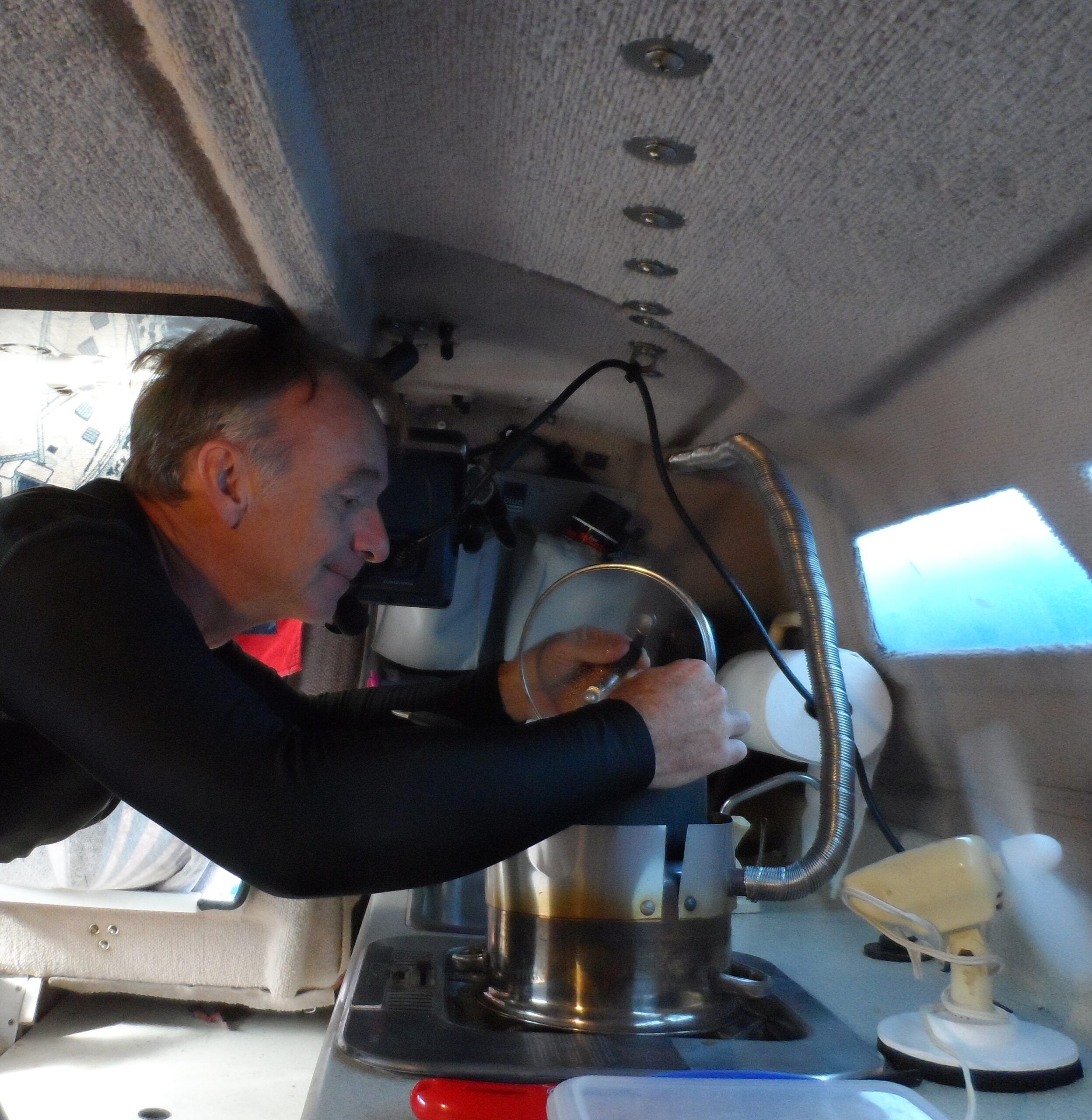 Cooking lunch on the top platform. Cooking takes 3-4 times longer than it would on the flame, but you won’t burn anything, and so long as it is warming the cabin, often there is no rush. The heater can easily be moved to one side (when cool) for proper cooking. (Photo/ Drew Frye)