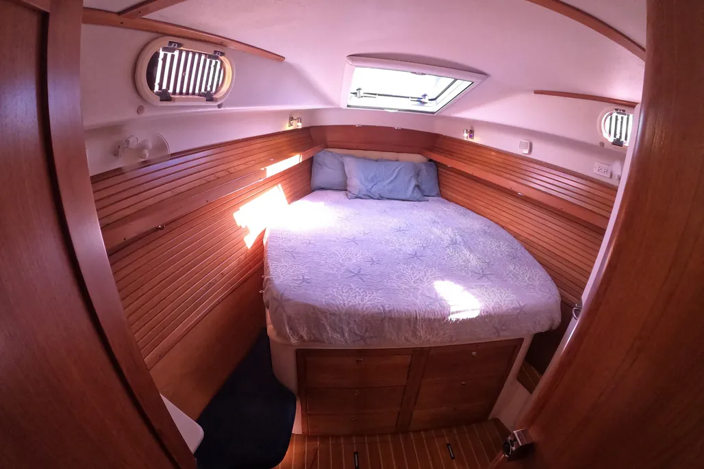 This 2005 Morgan 440's V-berth sleeps two in comfort, positioned under the large opening deck hatch and two opening portlights that flood the cabin with natural light and provide excellent ventilation during warm nights at anchor. The pedestal bed design allows ample storage underneath. (Photo courtesy of YachtWorld.com)