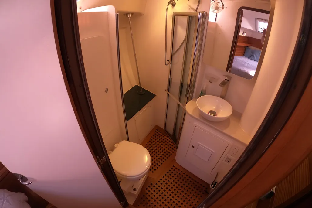 This 2005 Morgan 440's large ensuite head compartment forward serves the V-berth. A separate shower stall, white gelcoat surfaces and proper ventilation make this private head a practical addition for cruising couples or families on extended passages. (Photo courtesy of YachtWorld.com)