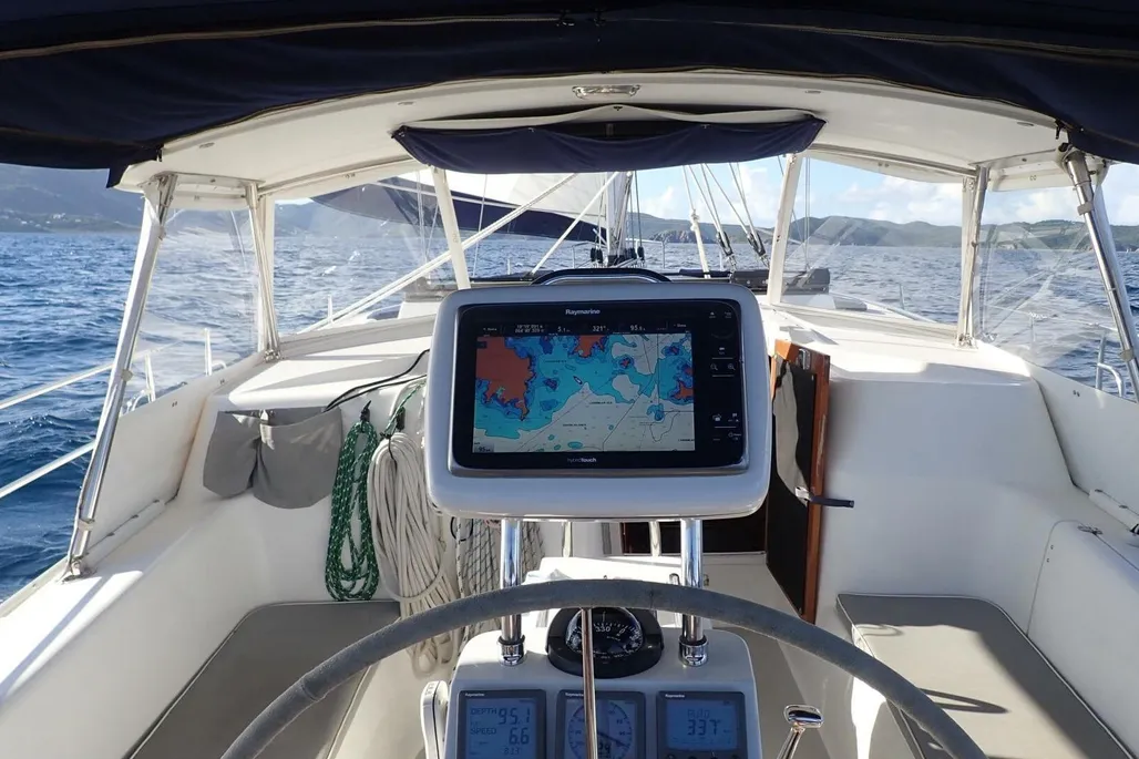 This 2008 Morgan 440's cockpit, enclosed with a full dodger and bimini combination, offers weather protection underway. Self-tailing two-speed winches mounted on the coamings are within easy reach of the helmsperson, while a Raymarine chartplotter and traditional instruments keep the navigator informed. The spacious seating area and single wheel steering make this 46-footer surprisingly manageable for a cruising couple. (Photo courtesy of BVI Yacht Sales)