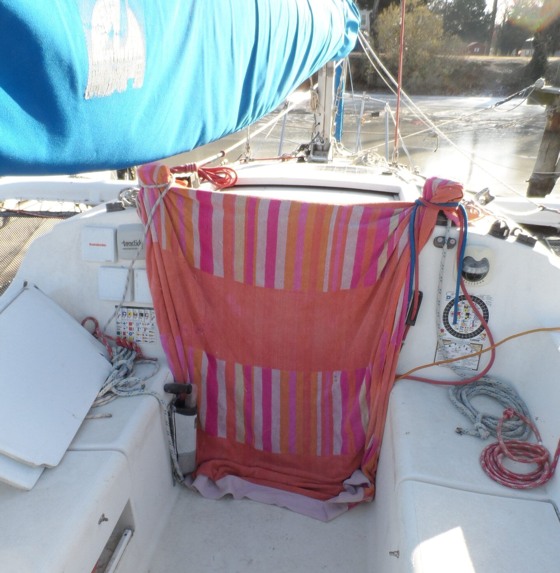 The most efficient way of sealing a drop-board entrance from the cold while coming and going is to drape a heavy beach towel or similar over the opening so that it drags on the floor, securing the corners to the cabin top winches. Two layers work when it is cold. (Photo/ Drew Frye)