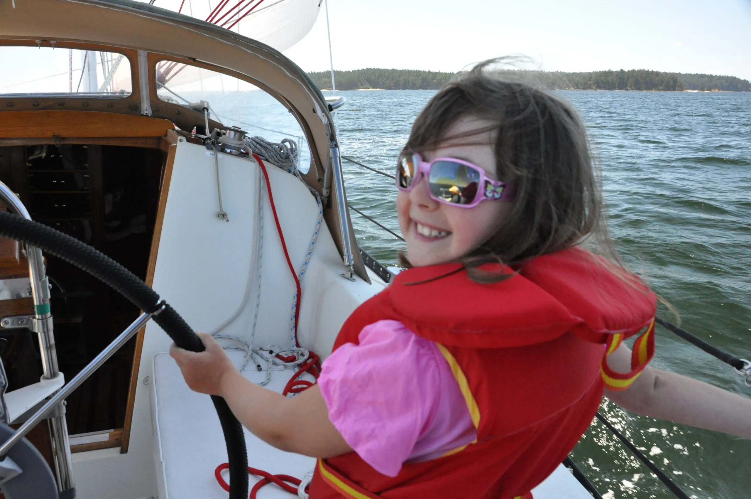 Natasha, age 8, with the sailing bug. Matching your shades to your shirt keeps that life jacket stylish.