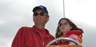 Author Bert Vermeer and his granddaughter Natasha, age 8, at the helm.