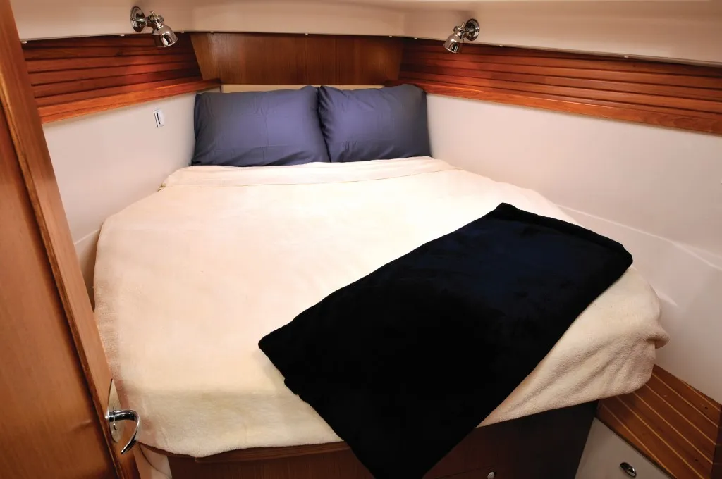 Forward, the island V-berth gives owners a proper cabin, with a large storage bin under the berth, additional drawers and a small desk/seat that reflect Catalina’s incremental refinements over decades. (Photo courtesy of Yacht World)