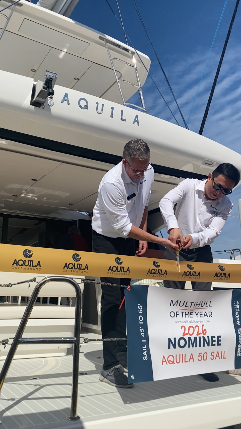 Aquila 50 Sail ribbon cutting: The Aquila 50 Sail on display in Miami was a hybrid model powered to twin Torqeedo Deep Blue straight-shaft electric motors. (Photo/ Doug Henschen)
