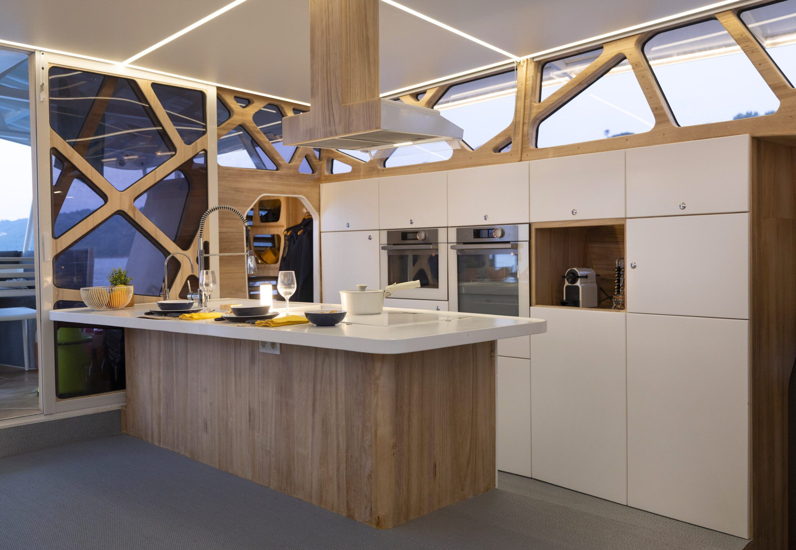 The design centers on the galley, which offers the comforts of land-based life aboard. 