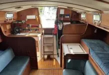 The port-side settee is less than 5 ft. long, making it a child's berth at best. Outboard of it, a narrow pilot berth is comfortable and secure, and mercifully isn't jammed up under the side decks. (Photo courtesy of SailboatListings.com)