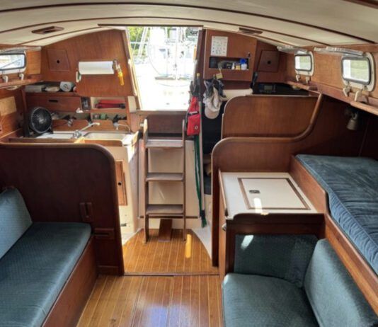 The port-side settee is less than 5 ft. long, making it a child's berth at best. Outboard of it, a narrow pilot berth is comfortable and secure, and mercifully isn't jammed up under the side decks. (Photo courtesy of SailboatListings.com)