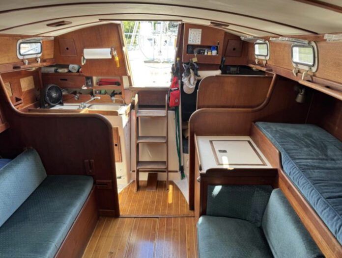 The port-side settee is less than 5 ft. long, making it a child's berth at best. Outboard of it, a narrow pilot berth is comfortable and secure, and mercifully isn't jammed up under the side decks. (Photo courtesy of SailboatListings.com)
