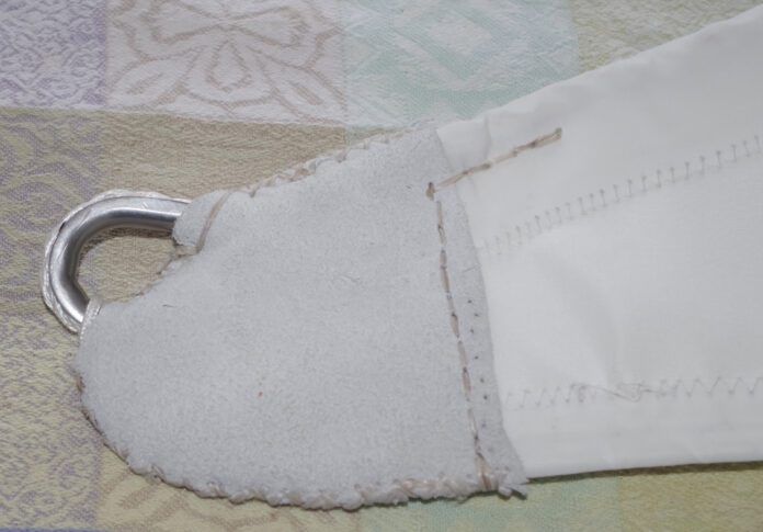 Once you have finished all the stitching the head and tack are covered with soft leather. It looks neat but more importantly protects the stitching underneath. The edges are done with cross stitching. The line across the bottom of the leather is done with a saddle stitch.