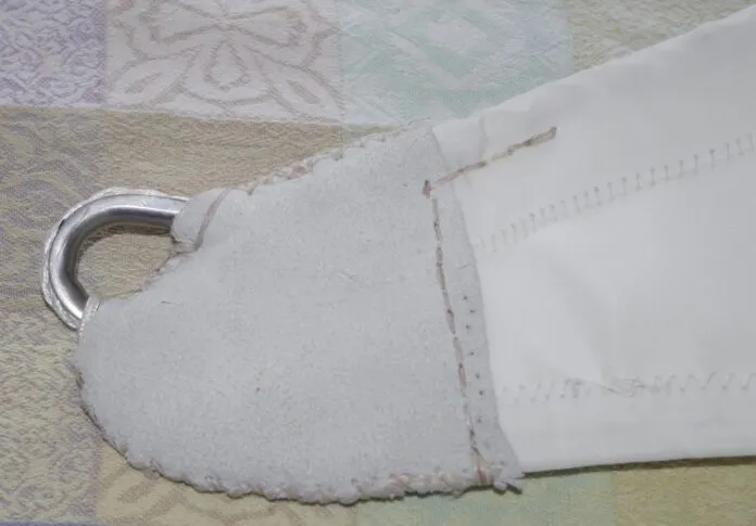 Once you have finished all the stitching the head and tack are covered with soft leather. It looks neat but more importantly protects the stitching underneath. The edges are done with cross stitching. The line across the bottom of the leather is done with a saddle stitch.