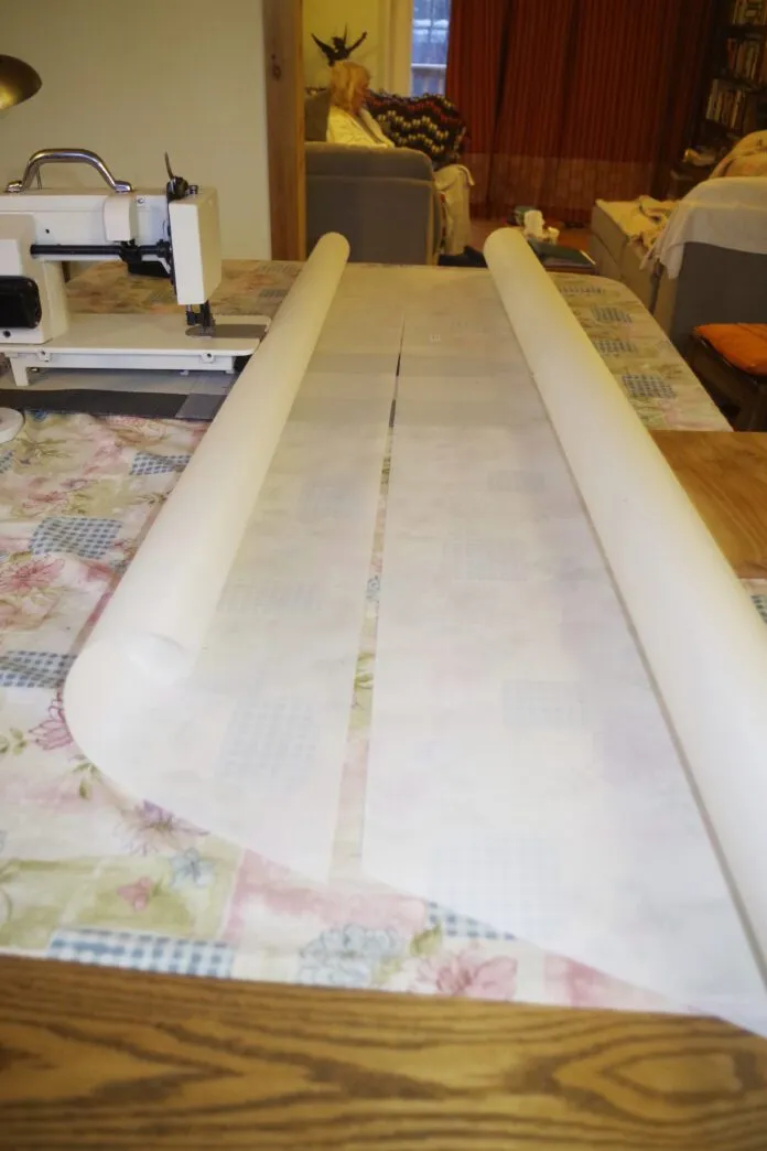 You start by sewing some panels together. Note that the sail shape is created by the curve cut into the edge of each panel. They look straight but they are not! You can see the amount of curve from this picture. Accuracy is very important when putting the panels together. You stick the panels together using the double-sided tape provided. Make sure you follow the seam line marked on the panel and work in short sections.