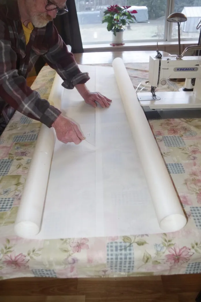 Place the double-sided tape near the edge of the seam line, peal a short length of the cover off and fold it to one side. Starting at the straightest edge firmly press the first few inches of the panels together. Now line up the next section. While holding it in place pull about six inches of the backing cover out and press this section together. Work across the seam in this way until you get to the other side. This ensures you line the panels up accurately.