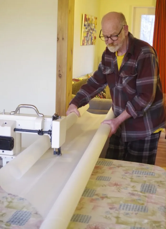 To sew the seam, roll both panels towards the seam. This enables you to hold the material and feed it through the machine. The rolls are stiff enough to allow you to steer the seam through the machine. If you are doing three rows of stitching, start with the center one and then place the other two close to the edges. For two rows of stitching, each one should be close to the edge, about 1/8- to ¼-in. clear of the edge.